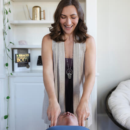 Hands-on shoulder contact during a care session at Holistic Alignment Strategies